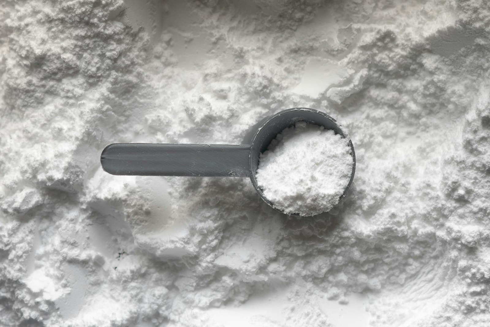 Scoop resting in a pile of fine white powder